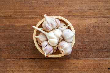 Fresh garlic on wood background