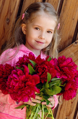 cute little girl with peonies spring