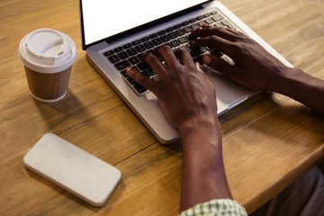 Poster - Hands typing on a laptop