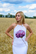 © gorosi - Beautiful young lady in white dress, wheat field background