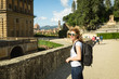 A wide smiling young woman enjoying the Boboli Gardens in Florence, Italy