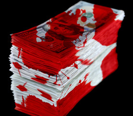 Poster - Stack of dollar banknotes with bloodstains isolated on black background