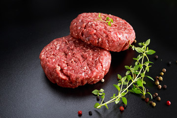 Home HandMade Raw Minced Beef steak burgers on black board