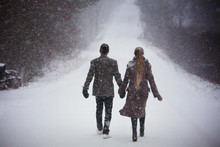 Young Couple Walking In Snow