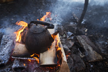 Kettle Of Boiling Water On Campfire In The Forest