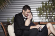 © Cavan Images - Couple flirting at formal party