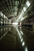 Empty Abandoned Warehouse Building Reflecting In Water