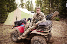 Man In Camouflage Sitting On ATV