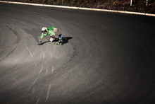 Downhill Skater Racing On Mountain Road