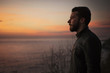 © Cavan Images - Man by sea at sunrise