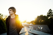 © Cavan Images - Man on roof at sunset