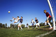 © Cavan Images - Friends playing soccer at field