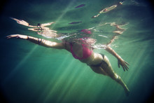 Woman Swimming In Sea