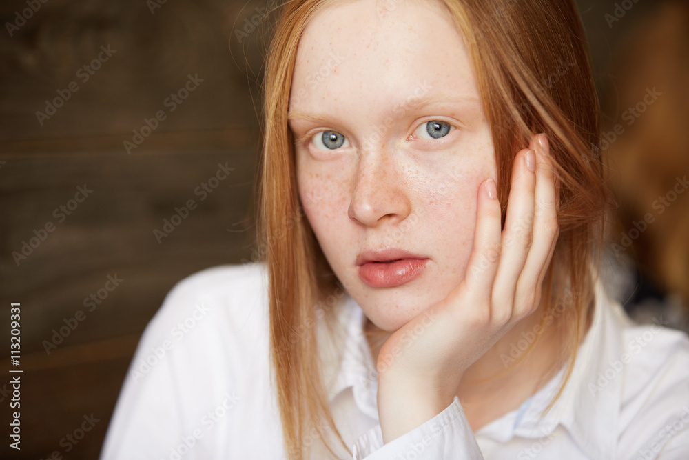 Close up portrait of Caucasian blue-eyed girl with blond long hair ...