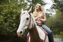 Smiling Woman Looking Away While Riding Horse