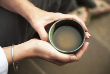 Close Up Of Woman's Hand Holding Tea Cup