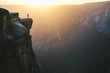 © Cavan Images - Man standing on mountain peak during sunset