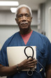 © Cavan Images - Portrait of senior doctor standing in hospital