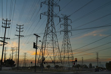 Silhouette Of Electricity Pylons,