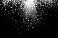 Freeze Motion Of White Powder Coming Down, Isolated On Black, Dark Background. Abstract Design Of Falling Dust Cloud. Particles Cloud Screen Saver, Wallpaper With Copy Space. Rain, Snow Fall Concept