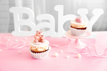 Wall Mural - Letters of word baby and cupcakes on the table