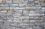 Fototapeta  - Close up of modern style design decorative uneven cracked real stone wall surface with cement, old vintage