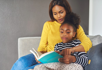 Mom and daughter reading a book