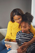 © Flamingo Images - Afro american woman and child with tablet