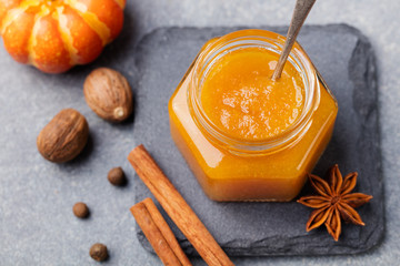 Wall Mural - Pumpkin confiture, jam, sauce with spices on stone table Top view