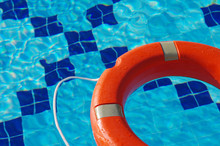Life Ring In The Pool. Life Ring On Blue Water.