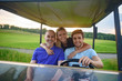 © Yakobchuk Olena - Attractive family in their golf cart