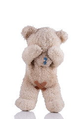 Toy bear with adhesive bandages on his private parts