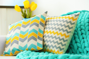 Wall Mural - Stylish pillows with turquoise plaid on white couch