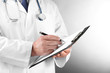 Professional doctor with clipboard on grey background