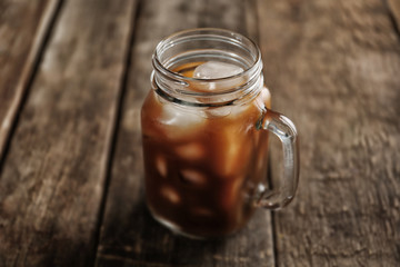 Canvas Print - Jar of ice coffee on wooden table