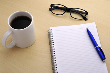 Close Up View Cup of Coffee with Note Book