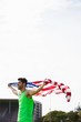 © WavebreakMediaMicro - Athlete posing with american flag