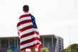 © WavebreakMediaMicro - Athlete with american flag wrapped around his body