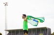 © WavebreakMediaMicro - Athlete posing with brazilian flag after victory