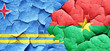 aruba flag with Burkina Faso flag on a grunge cracked wall