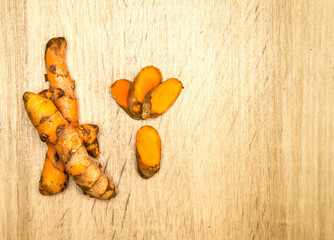 Poster - turmeric  roots on wooden plate