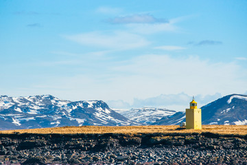 Canvas Print - Lighthouse in a landscape with mountains