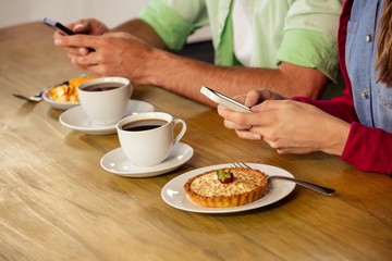 Wall Mural - Couple using smartphones