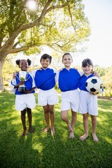 portrait of children soccer team in raw smiling