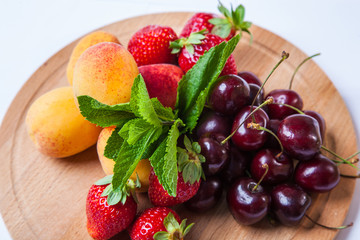 Wall Mural - fruits and berries on a wooden cutting board