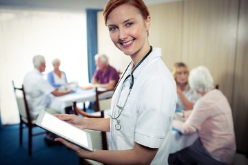 Wall Mural - Portrait of a nurse with tablet computer