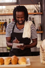 Poster - Portrait of smiling hipster taking an order at work