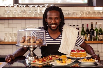 Poster - Portrait of hipster employee posing with pastries 