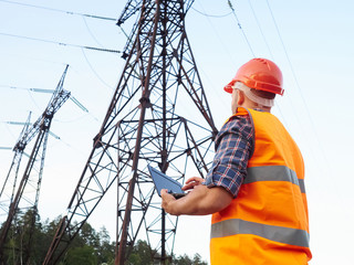 Electrical engineer working. Talking on the phone and working wo