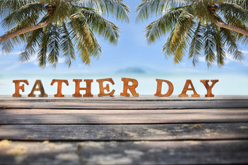 Word of wooden father day on plank and sea view background, happy father day concept and tropical beach idea